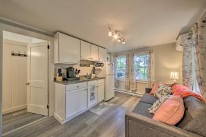 a living room with a couch and a kitchen at Updated Tiny House Walk to Wiscasset Village in Edgecomb