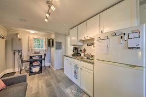 a kitchen with white cabinets and a white refrigerator at Updated Tiny House Walk to Wiscasset Village in Edgecomb