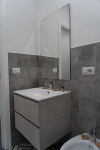 a bathroom with a sink and a mirror at Zagara e Lumia in Catania