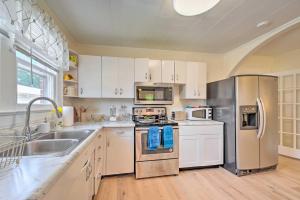 a kitchen with white cabinets and stainless steel appliances at Winston-Salem Retreat with Yard about 6 Mi to Dtwn! in Winston-Salem