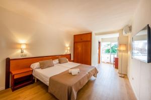 Posteľ alebo postele v izbe v ubytovaní IROCO HOSTAL