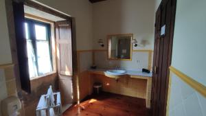 a bathroom with a sink and a mirror and a window at Casa Dos Cregos in Bascuas +84 photos
