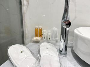 a bathroom with a sink and a toilet and a shower at Hotel Alpha in Sant'Agnello