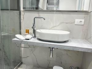 a white sink on a counter in a bathroom at Hotel Alpha in Sant'Agnello