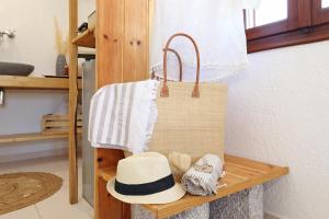 卡利诺岛Spongia Apartments Kalymnos的长椅上放着一顶帽子和一个钱包。 更多140张照片