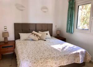 a bedroom with a large bed and a window at Villa Sikia in Katokhórion +24 photos