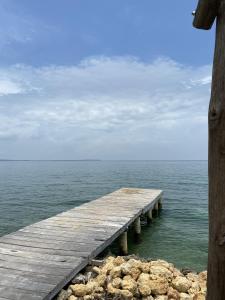 a wooden pier in the middle of the ocean at Centro Ubuntu in Isla Grande
