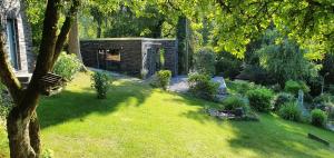 a garden with a building in the grass at 1Step2AllNature Tinyhouse in Wuppertal