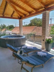 a group of loungers on a patio with a hot tub at New, modern, luxury apartment Ivan with jacuzzi in Drinovci