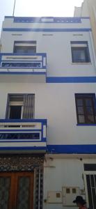 a blue and white building with windows and a door at Marblava 1 in Vinarós