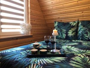 a room with a bed with a table with wine glasses at OSTOJA SŁAWIANOWO nad jeziorem in Sławianowo