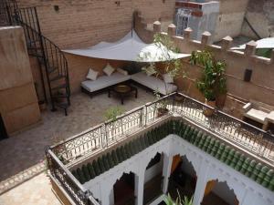 an overhead view of a balcony with a couch and a table at Riad Dialna in Marrakesh