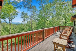 a deck with benches and a view of the woods at Bear Cloud in Blue Ridge