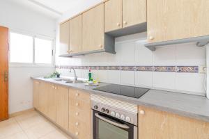 a kitchen with a sink and a stove top oven at Flatguest Fuerteventura Airport in Puerto del Rosario