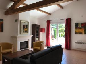 a living room with a table and a fireplace at French country home III in Les Forges