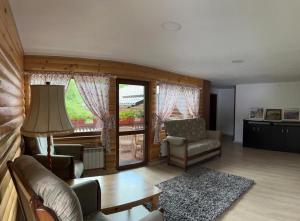 a living room with a couch and chairs and a table at Casa Luca in Ceahlău