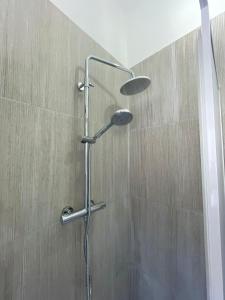 a shower with a shower head in a bathroom at Sweet relax in Cassino
