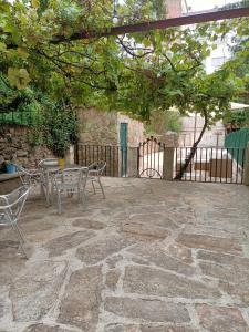 a patio with a table and chairs and a fence at Bico de Pedra in Santiago de Compostela