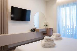 a hotel room with a vanity and a mirror at GRAND PATELLI in Myrina