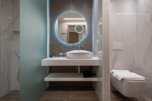 a bathroom with a sink and a mirror at GRAND PATELLI in Myrina
