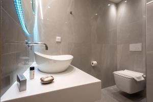 a bathroom with a sink and a toilet at GRAND PATELLI in Myrina