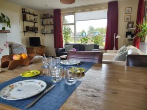 a dining room table with plates and glasses on it at b&b de Vlinder in Hardenberg