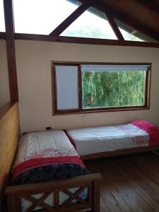 En eller flere senge i et værelse på CARELHUE GUAZU