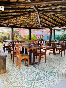 a group of tables and chairs under a pavilion at Brisa da Costa Suites in Macaé
