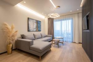 a living room with a couch and a table at GRAND PATELLI in Myrina