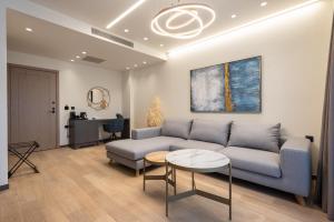 a living room with a couch and a table at GRAND PATELLI in Myrina