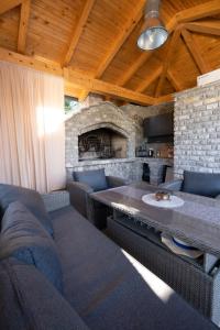 a living room with couches and a stone fireplace at Villa Kula in Bihać