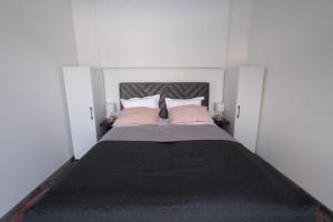 a bedroom with a large bed with two pink pillows at Villa Kula in Bihać +45 photos