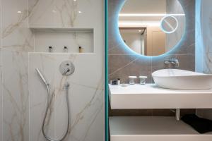a bathroom with a shower and a sink and a mirror at GRAND PATELLI in Myrina