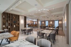 a rendering of a restaurant with tables and chairs at GRAND PATELLI in Myrina