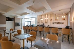 a bar in a restaurant with chairs and tables at GRAND PATELLI in Myrina