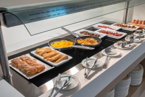 a buffet with many different types of food on it at GRAND PATELLI in Myrina