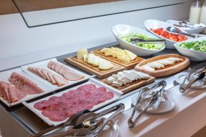 a bunch of different types of meats and cheese on a counter at GRAND PATELLI in Myrina
