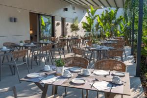 a row of tables and chairs on a patio at GRAND PATELLI in Myrina