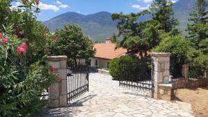 a gate to a house with mountains in the background at Private Villa with Panoramic View in Ayía Evthimía