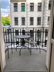 a balcony with tables and chairs in front of a building at Apartament 11A- Hvile in Toruń