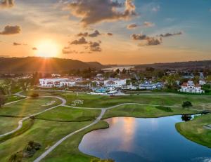 a view of a golf course with the sun setting in the background at Omni La Costa Resort & Spa in Carlsbad