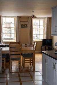 a kitchen and dining room with a table and chairs at Ashe Street in Clonakilty