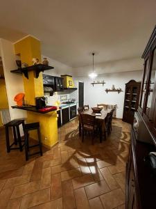 a kitchen and dining room with a table and chairs at Villetta Vista Mare Cornino in Custonaci