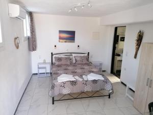 a bedroom with a bed in a white room at Countryside Retreat 4 in Agios Arsenios