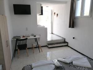 a white living room with a table and a chair at Countryside Retreat 4 in Agios Arsenios +43 photos