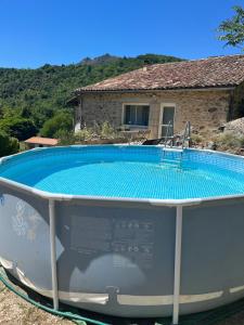 a swimming pool in front of a house at la maison de bonneval in Jaujac