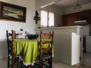 a kitchen with a table with a green table cloth at Vintage Beach House in Alexandroupoli