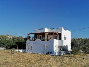 a white house sitting on top of a field at Countryside Retreat 4 in Agios Arsenios