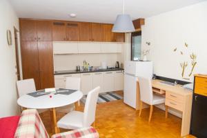 a kitchen and dining room with a table and chairs at Apartment Karlie - cycling - other unique experiences in Rogaška Slatina