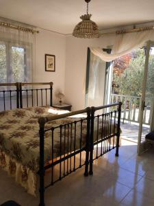a bedroom with a bed and a large window at Vintage Beach House in Alexandroupoli